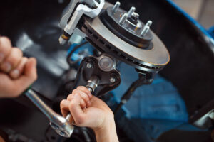 worker repairing vehicle on lift car service FAF7HLD